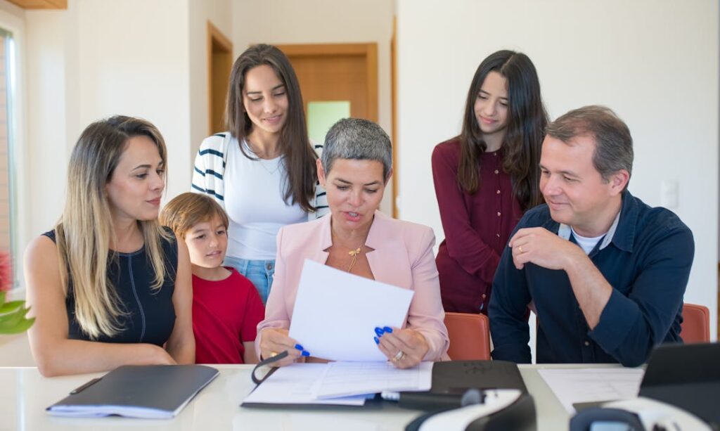 Mastering the First Impression: Your intriguing post title goes here A family meeting with a female realtor reviewing documents in a bright, modern room.